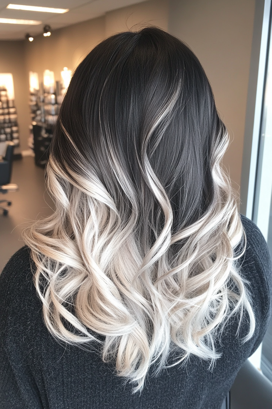 Women's hair color. Dark shadow roots with silver toned ends.